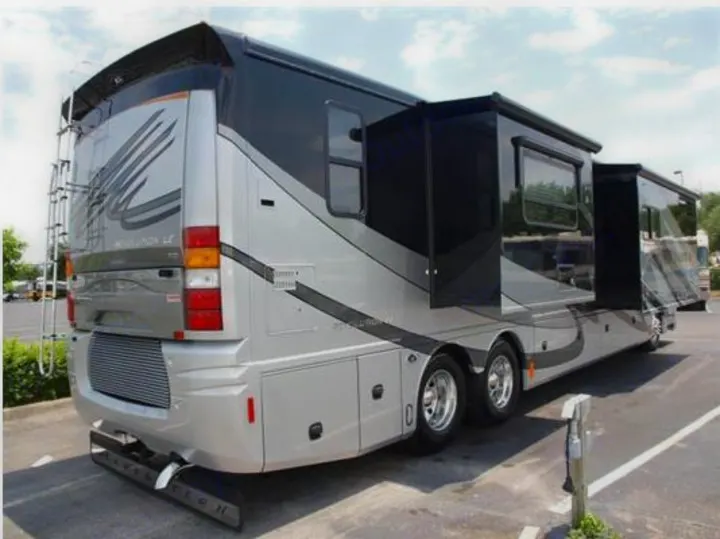 This luxury silver and black motorhome, a potential rv rental, features extended slide-outs for spacious living.. Fleetwood Revolution