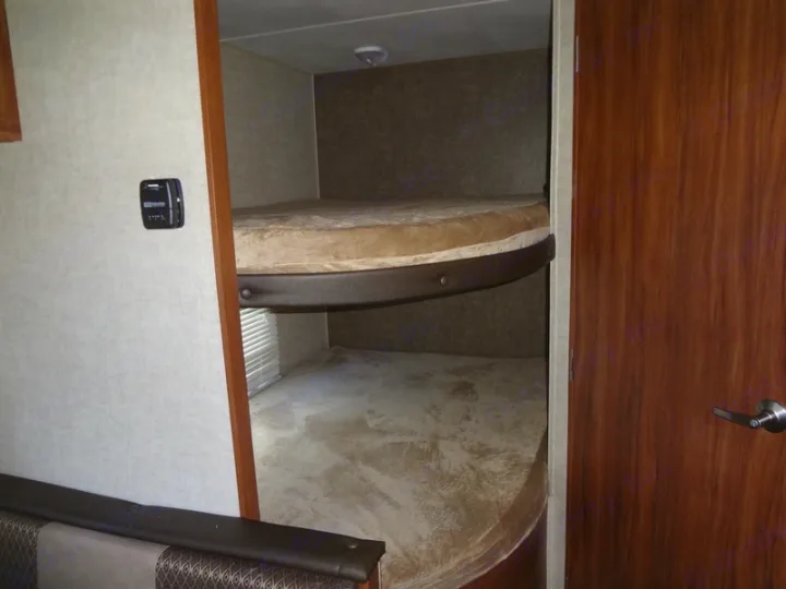 RV rental bunk beds within a travel trailer interior, offering cozy sleeping space for adventure-filled family trips.. Heartland Trail Runner 2017