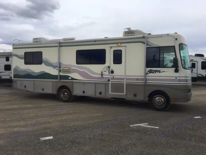 Spacious cream & grey RV with extended awning, perfect for an RV rental journey.. Fleetwood Other 2000