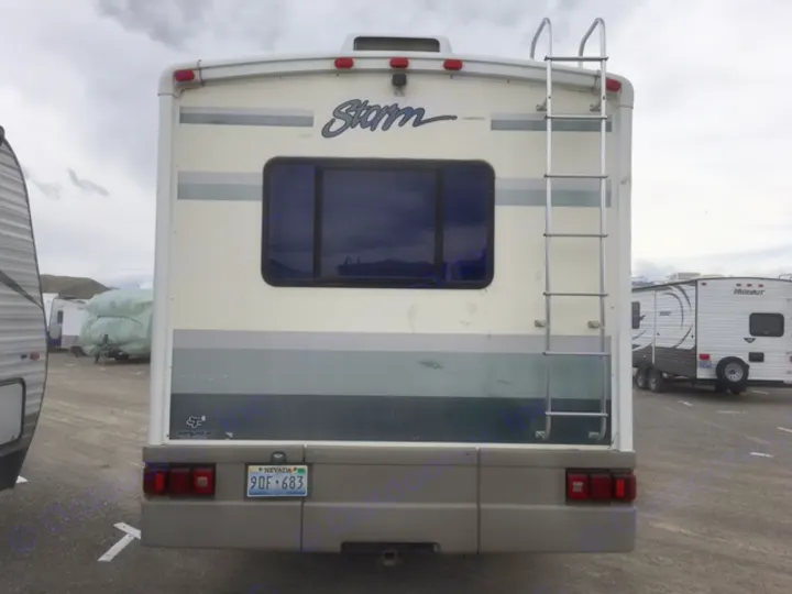 This Storm RV, perfect for rv rental, shows its rear: ladder, window, and Nevada license plate. Ready for travel!. Fleetwood Other 2000