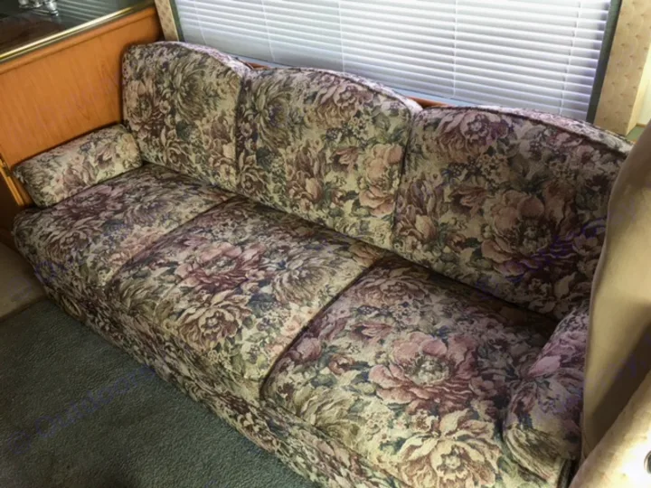 Comfortable floral sofa in this RV rental offers a cozy living space for your adventures.. Fleetwood Other 2000