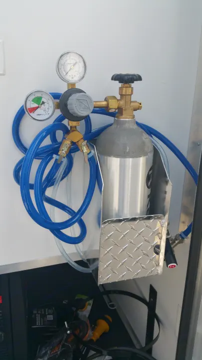 This RV rental features a mounted CO2 tank system with regulator, gauges, and hoses, ready for beverage dispensing.. Ready 2 Roll Party Central 2021