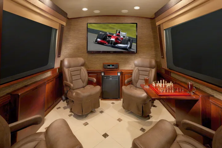 Experience ultimate comfort in an RV rental! This luxurious mobile lounge features TV, cozy chairs, and a chessboard.. Dynamax Corp Grand Sport 2015