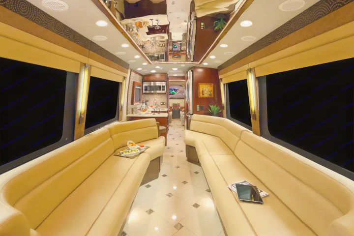 Step inside this luxury RV rental: a spacious interior with plush seating, a kitchen, and entertainment for comfortable travels.. Dynamax Corp Grand Sport 2015