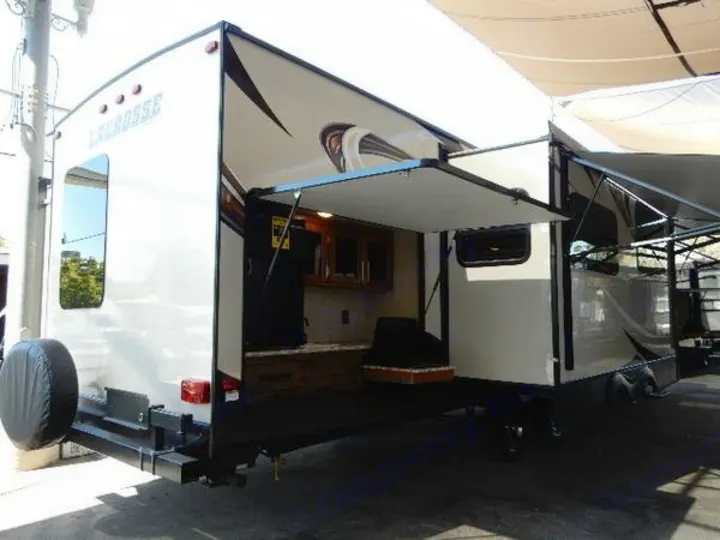 Spacious RV rental travel trailer featuring an open outdoor kitchen and extended awnings for camping comfort.. Prime Time Lacrosse 2017
