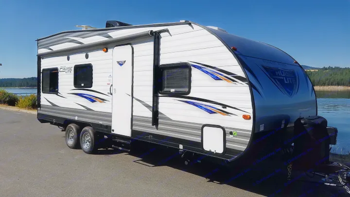 RV rental: A white and black Forest River Salem Cruise Lite travel trailer parked by a lake, ready for outdoor adventures.. Forest River Salem Cruise Lite 2017