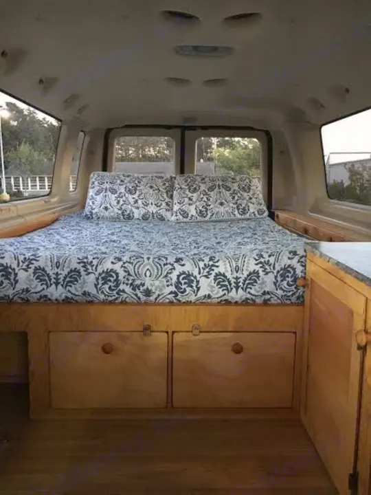 Floor plan includes a full bed, cabinets and deep drawers. There is even a cubby for dirty shoes!. Ford E350 Extended Passenger Van 2004