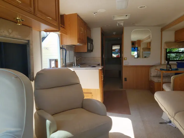A roomy and stately interior awaits you when you reach your destination and expand the living room slide out.. Winnebago Adventurer 2001