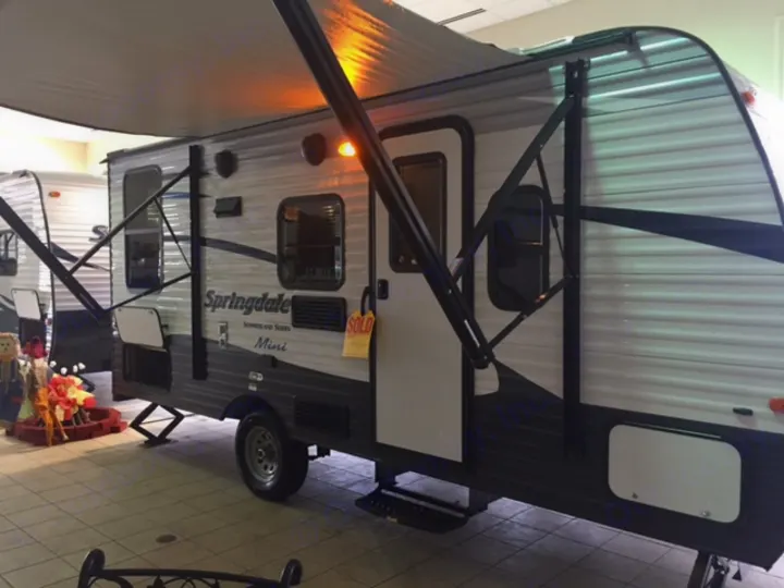 The RV with it's awning out on the showroom floor when first purchased in February 2017.. Keystone Springdale 2016