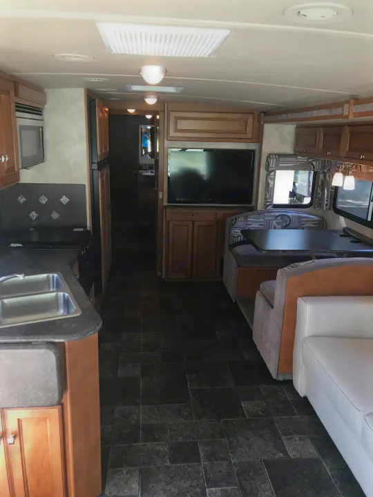 booth, couch and kitchen. Winnebago Itasca Sunstar35B 2013