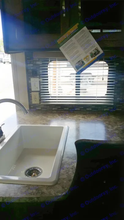 RV rental: Kitchen area featuring a white sink, chrome faucet, and speckled countertop, with a window and blinds, plus electrical outlets.. Forest River Salem Cruise Lite 2018