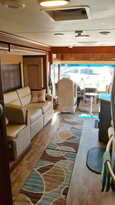 Spacious RV rental interior featuring comfortable seating, modern flooring, and ample light, ideal for travel.. Forest River Georgetown 2017