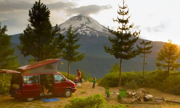 Scenic RV rental adventure: family campsite with mountain views, campfire, and cooking outdoors.. Volkswagen Eurovan weekender 2003