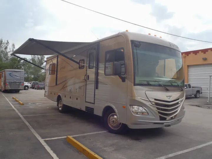 This spacious light brown Fleetwood Storm RV with an extended awning is available for rv rental.. Fleetwood Storm 2015