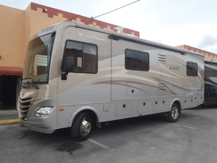 Fleetwood Storm RV motorhome parked. Explore your next adventure with this spacious rv rental.. Fleetwood Storm 2015