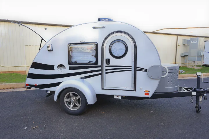 This compact white teardrop RV, featuring stylish black stripes, is perfect for your next rv rental adventure. Ready to hit the road!. T@G MAX 2017