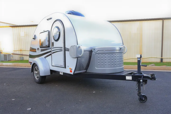 This compact grey teardrop travel trailer, available as an RV rental, is perfect for camping adventures.. T@G MAX 2017