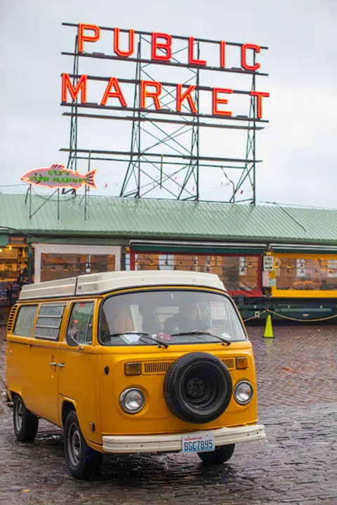 Vintage yellow VW camper van (rv rental) at Seattle's iconic Pike Place Market.. Volkswagen Westfalia 1977