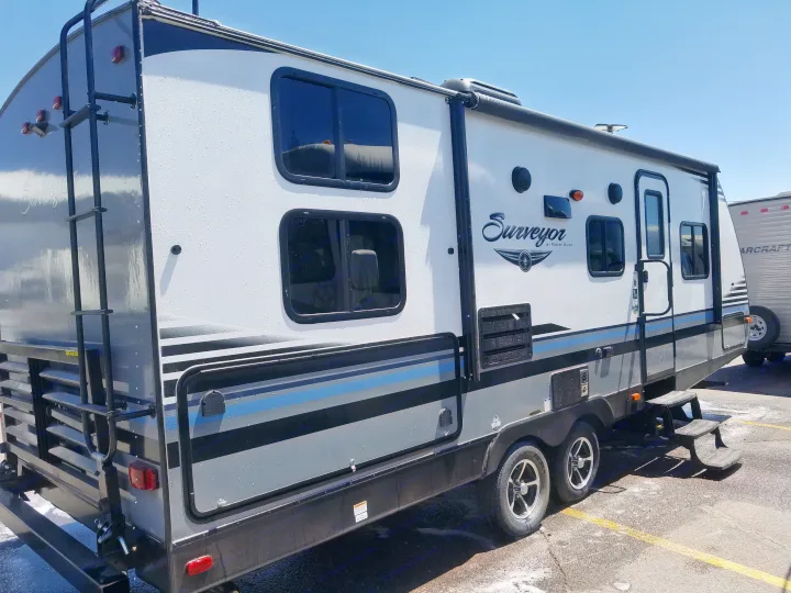 Freshly washed Surveyor travel trailer, perfect for your next rv rental trip. Clean white & grey exterior.. Forest River Surveyor 2018