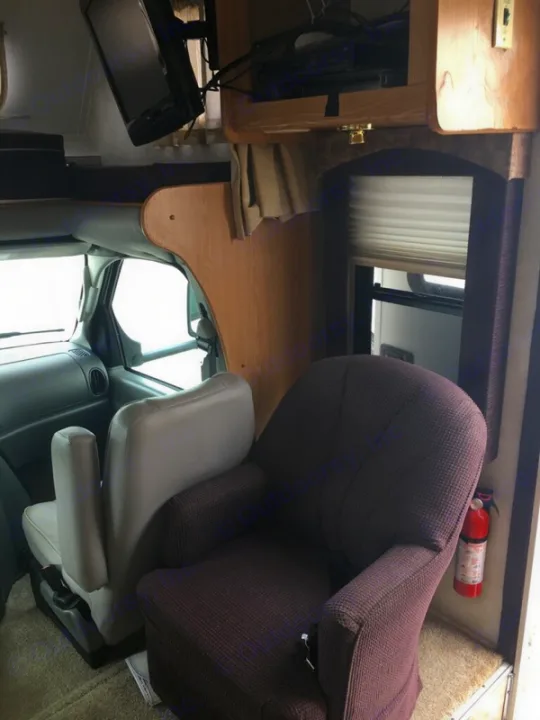 Barrel Chair, overhead TV, and Storage, Satellite, spacious driving area, overhead Bunk bed, fire extinguisher by the entreance. Ford Forrest River Sunseeker 2005