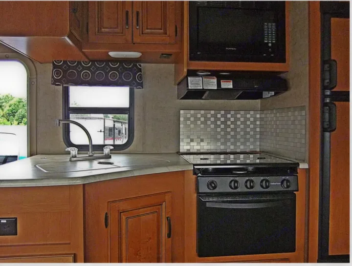 This RV rental has a complete kitchen setup: sink, oven/stove, and microwave.. Forest River Sunseeker 2017