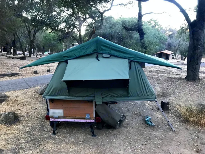This 94" x 55" tent folds sits on top of a 40" x 48" x 24" storage box on a small trailer.. Mombasa Outdoors 9008 Expedition 2009