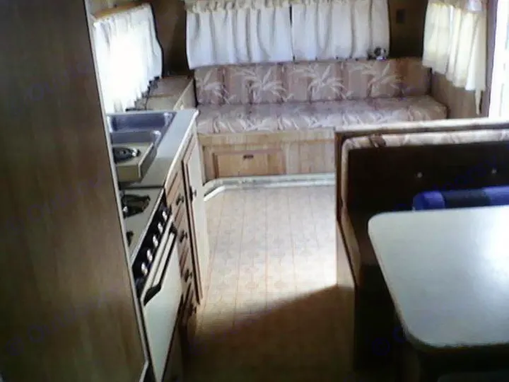 Very spacious and the sofa folds into a double bed as does the storage area directly above which folds out into another upper bunk double bed.  The dining area folds out to a third double bed and there are two single upper and lower beds in a separate sleeping space.. Heartland Prowler 1983