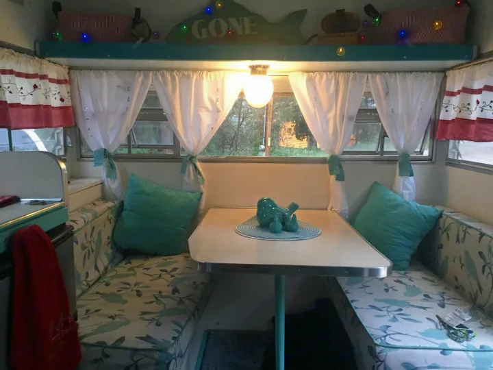 Dinette folds down to a twin bed . Shasta Airflyte 1965