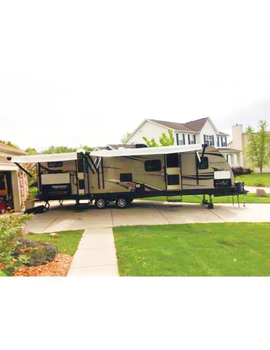Spacious 'Passport' RV travel trailer with extended slide-outs & awnings, parked on a driveway. Consider this RV rental for your trips!. Keystone Passport 2014