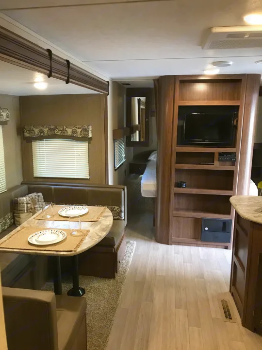 Discover the comfortable interior of this RV rental, complete with a dinette, entertainment center, and accessible bedroom.. Coleman Lantern 2018