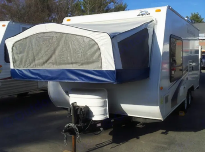 Shows how the Queen size bed opens up on exterior of camper.. Jayco Jay Feather Exp 2009