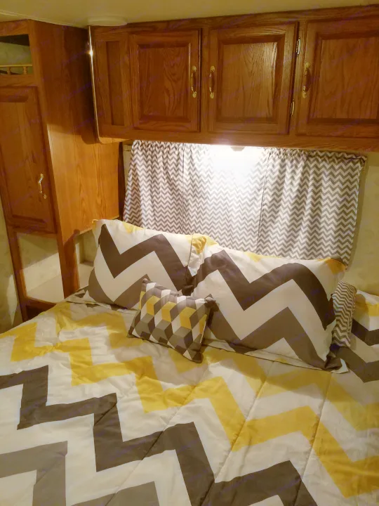 Queen bed in divided room. Cabinets for storage, more storage under bed.. Forest River Salem  Ultra Lite 2002