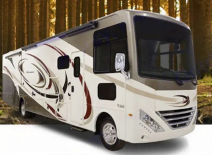 Explore nature! This beige & brown Class A motorhome, ideal for RV rental, is pictured in a lush forest.. Thor Motor Coach 35m 2017