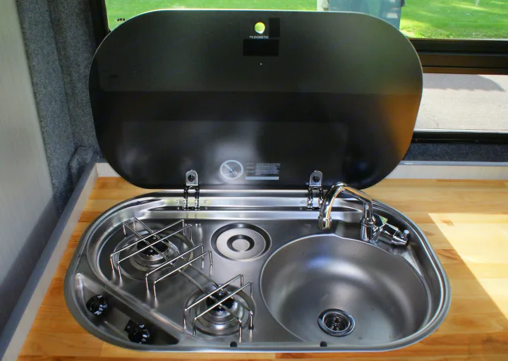 This RV rental features a compact Dometic kitchenette with a stainless steel sink and two-burner stove.. Dodge Promaster 2017