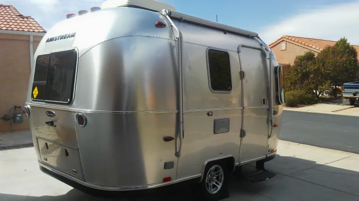 Classic silver Airstream Bambi travel trailer, a great choice for your next RV rental.. Airstream Sport 2015