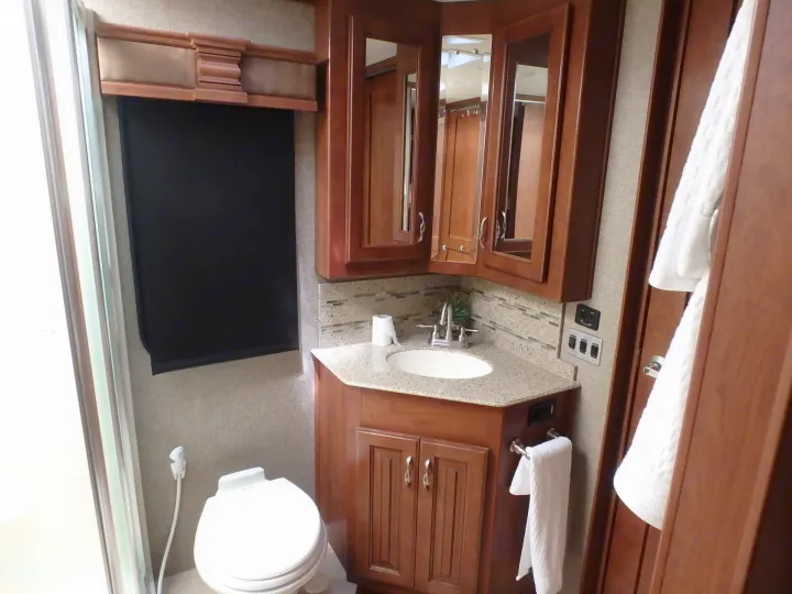 Bathroom with Commode and walk in shower. Fleetwood Discovery 2015