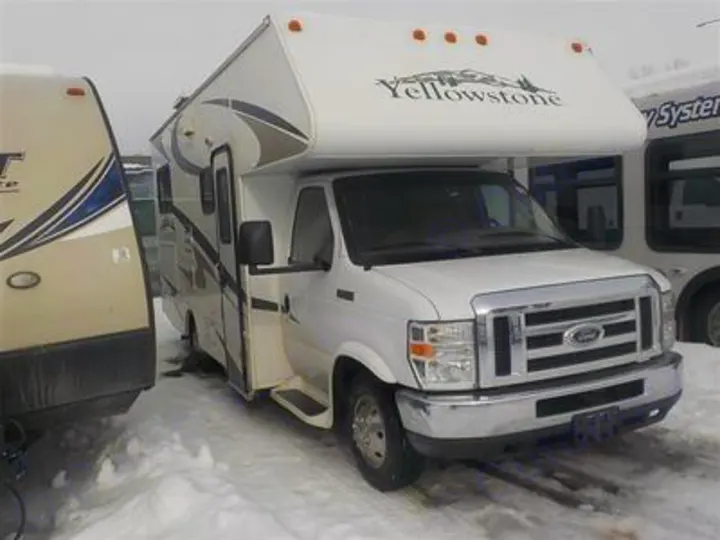 A white Ford Class C Yellowstone RV rental is parked in a snowy outdoor lot, ready for your next adventure.. Gulf Stream Yellowstone 2009