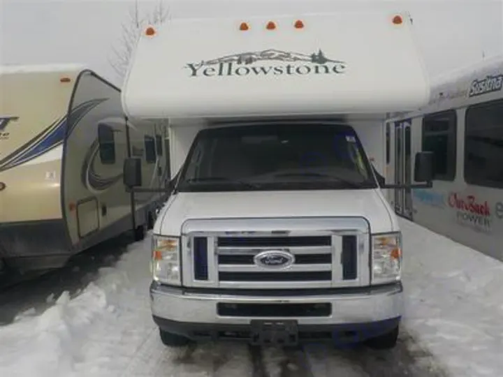 White Yellowstone RV rental, a Ford motorhome, parked in snow beside a tan travel trailer. Ideal for your winter trips.. Gulf Stream Yellowstone 2009