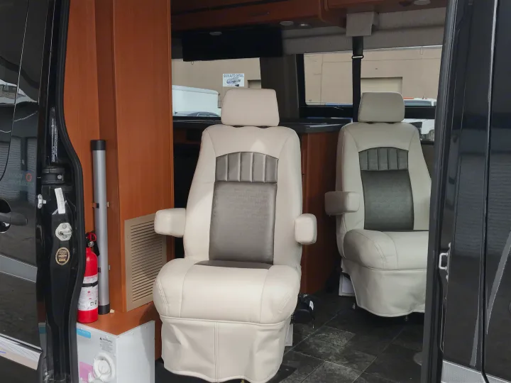 RV rental: luxurious interior with two white and gray captain's chairs, fire extinguisher for safety.. Winnebago Era 2014