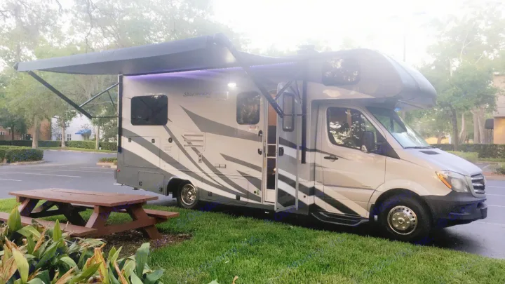 This Class C RV rental, parked with its awning extended and a picnic table nearby, is ready for your next road trip.. ForestRiver Sunseeker 2018