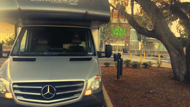 RV rental: A silver Mercedes-Benz Sprinter camper van, ideal for travel, parked outside Whole Foods Market.. ForestRiver Sunseeker 2018