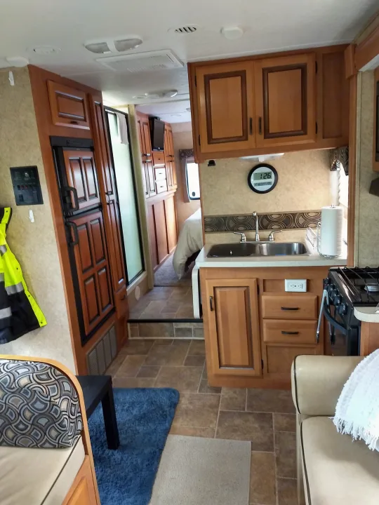 This RV rental offers a well-equipped kitchen, comfortable living space, and a cozy bedroom, ready for your travel adventures.. Forest River Sunseeker 2013