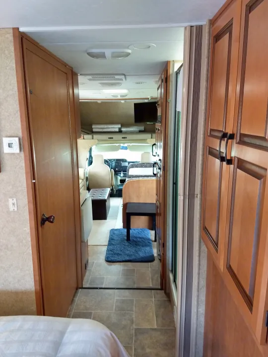 Explore this spacious RV rental interior: living area, full kitchen, bedroom, and bath. Perfect for your next adventure!. Forest River Sunseeker 2013