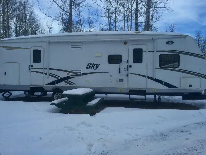 The picture shows the main entrance towards the front and the bathroom entrance towards the back. You can see the storage compartment at the front and the back and a picture of the automatic awning.. Gulf Stream Sky 2012