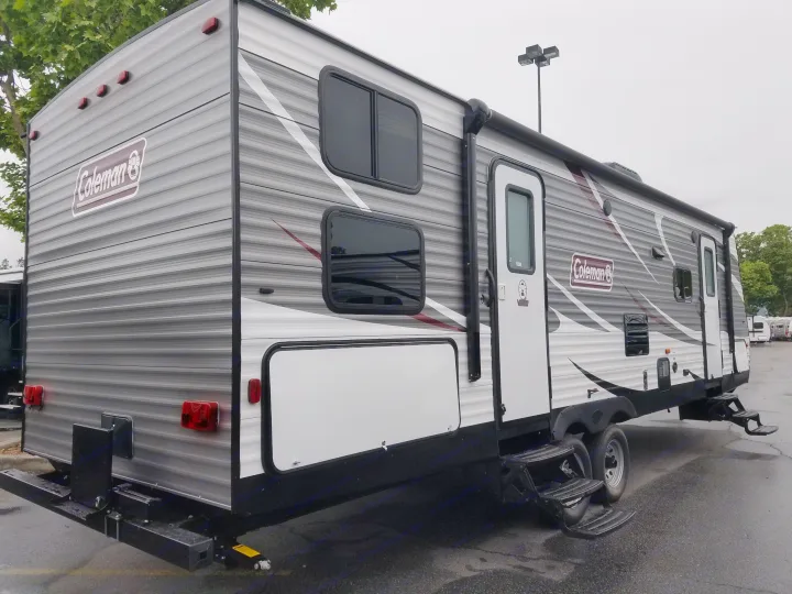 This Coleman travel trailer, ideal for rv rental, features a gray and white exterior with an awning and multiple windows.. Coleman 285bh 2017