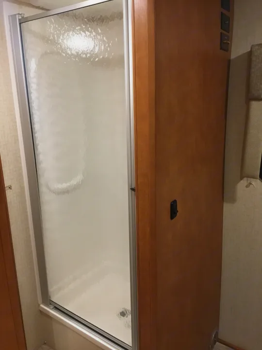 RV rental: Wooden bed platform with outlets above a lower frosted glass pull-out bed system.. Winnebago Minnie Winnie 2017