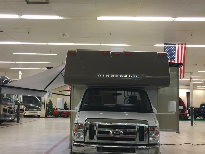Front view of a white Winnebago Class C RV in a showroom, perfect for exploring RV rental opportunities.. Winnebago Minnie Winnie 2017