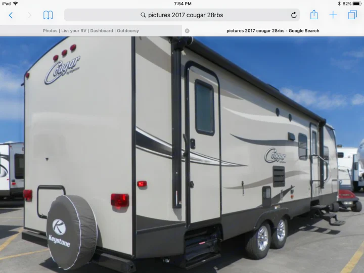 Beige 2017 Cougar 28RBS by Keystone travel trailer with a spare tire, perfect for rv rental vacations.. Keystone Cougar Half-Ton 2017