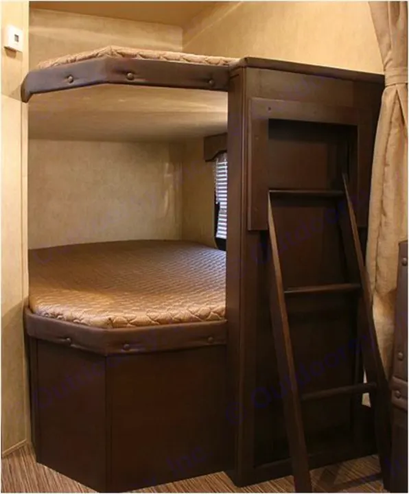 Inside an RV rental: a cozy bunk bed setup with ladder for compact sleeping arrangements.. Forest River Evo 2850 2019