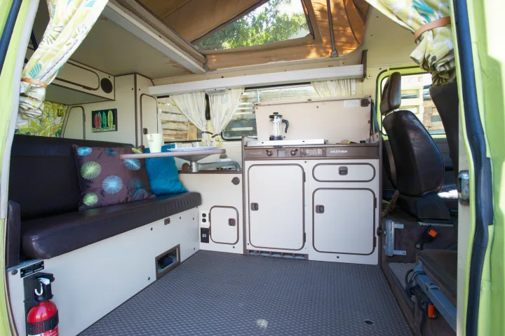 Spacious Westfalia camper van interior with kitchen, seating, and pop-top. Perfect for your next RV rental adventure.. Volkswagen westfalia 1984
